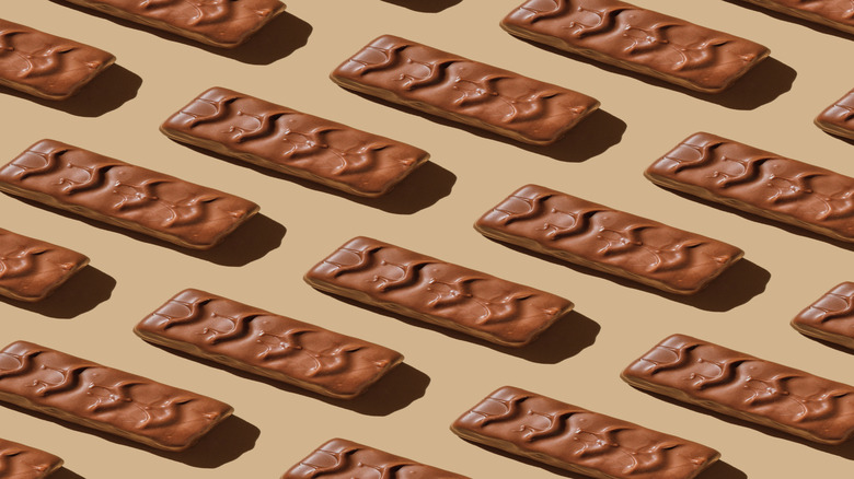 Chocolate candy bars laying on a beige table