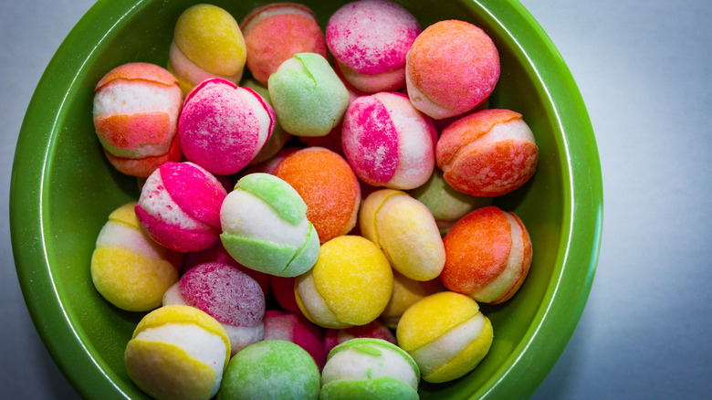 Green bowl holding colorful freeze-dried candy