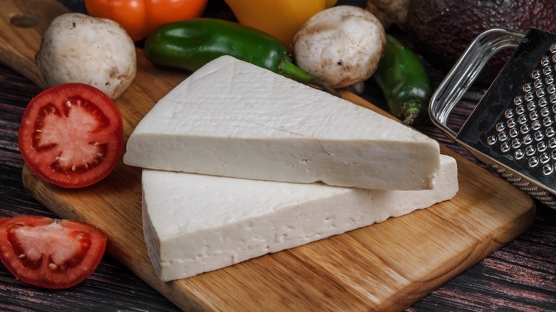 Cotija cheese and veggies on wooden board