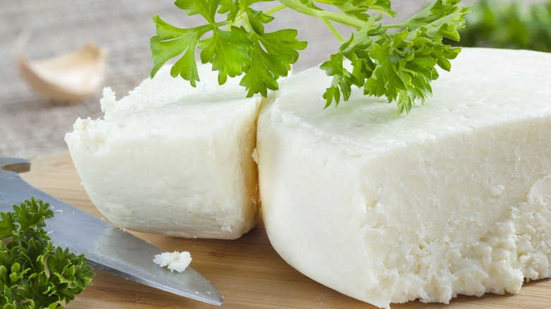 Cut cotija cheese block with cilantro