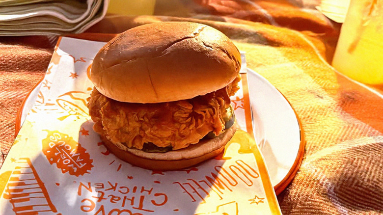 Popeyes Pickle Glaze Sandwich on picnic blanket