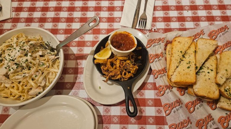 Various dishes from Buca di Beppo on a checkered tablecloth