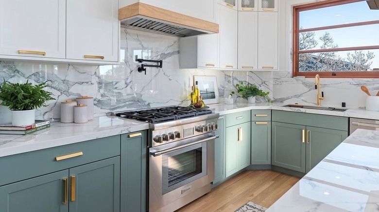 A pale green-colored kitchen featuring a Thermador oven