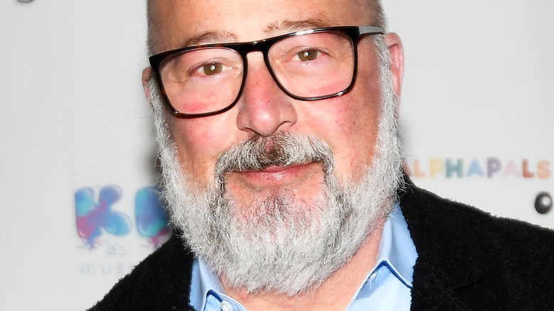 Andrew Zimmern with glasses and gray beard