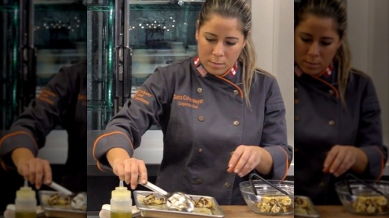 Chef Dana Cohen preparing a dish
