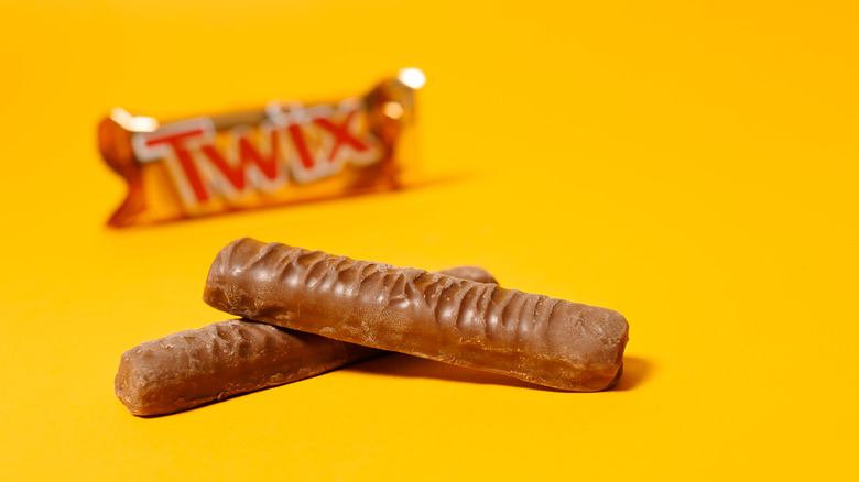 Twix candy in the foreground with wrapped bar in the background 