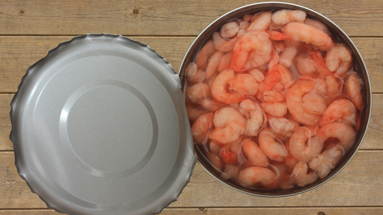 Bird's eye view of a can of shrimp in water