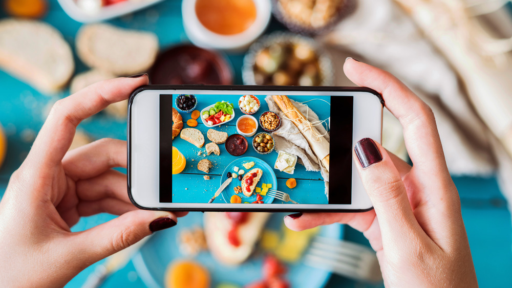 Woman taking photo of food