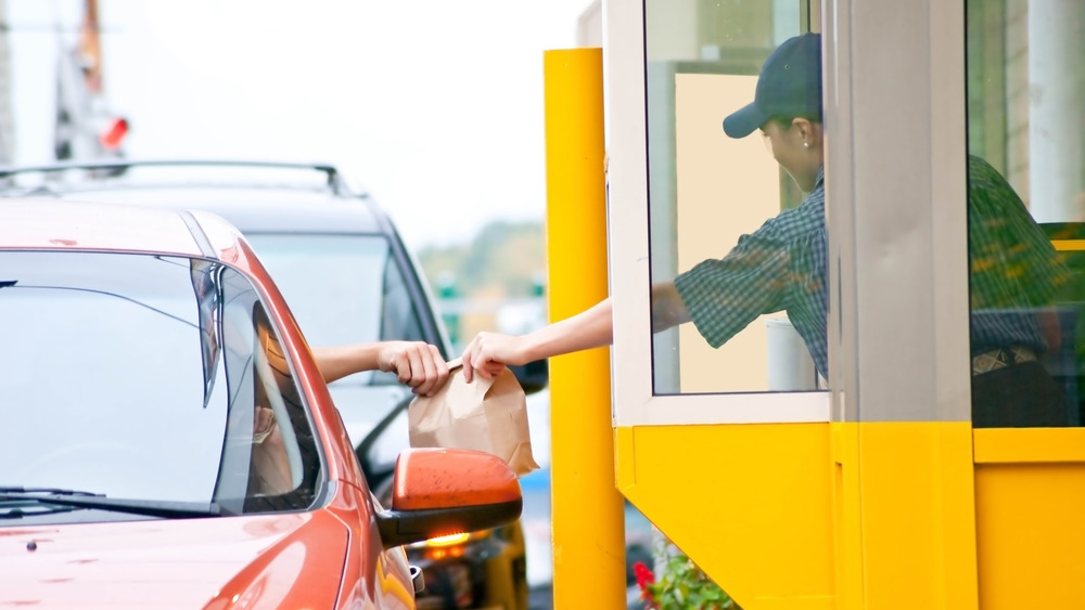 Person receiving takeout from drive thru