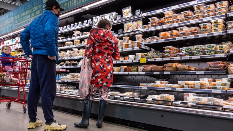 Family shopping in prepared food aisle 