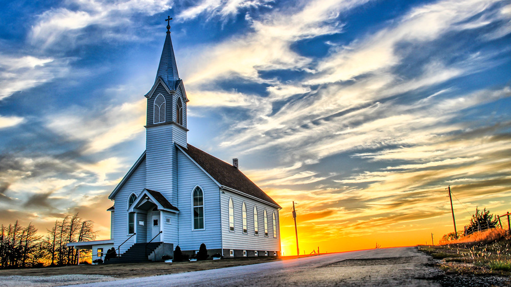 White church in a rural area at sunset