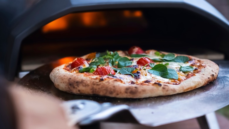 pizza coming out of oven