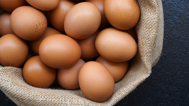 Brown eggs in burlap sack