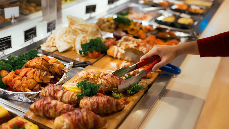 Person loading bowl at buffet