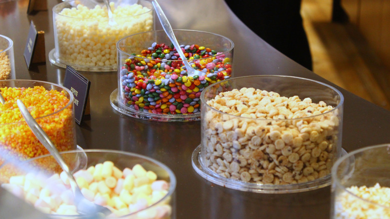 Containers full of ice cream toppings