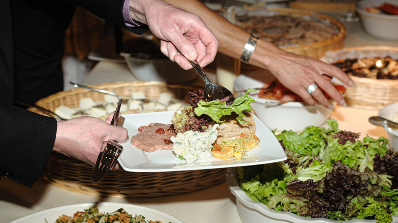 People helping themselves at a buffet