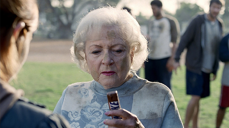 Betty White staring at a Snickers