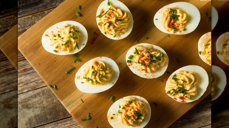 Deviled eggs on wooden board