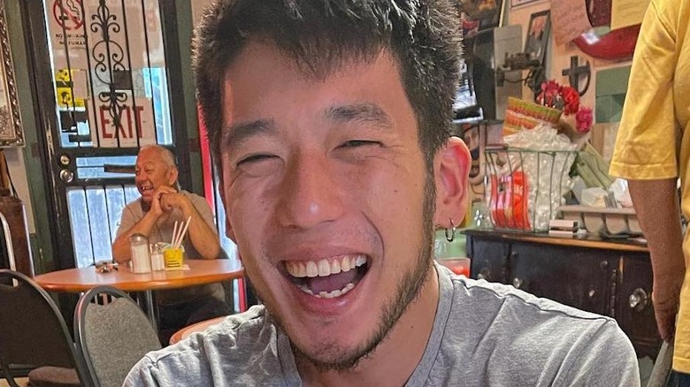 Shota Nakajima smiles in gray shirt