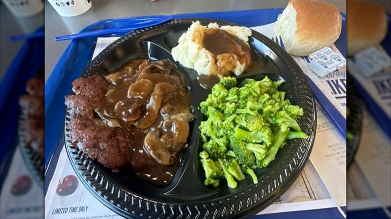 Culver's Chopped Steak Dinner on a black plate placed on a blue tray