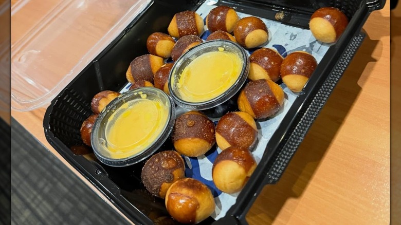 Culver's Pretzel Bites in a to-go container with a side of two cheddar cheese dipping sauces