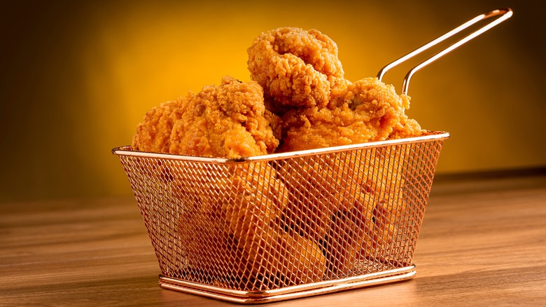 fried chicken in deep fryer basket