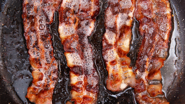 Bacon cooking on frying pan