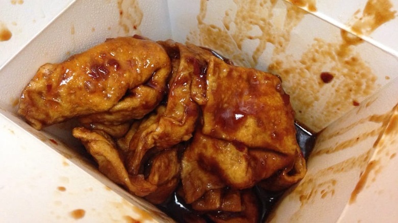 Hot and spicy wontons in a to-go box