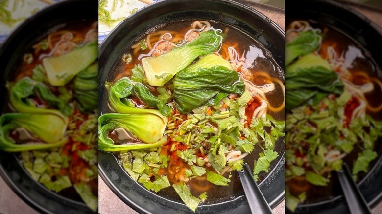 A black bowl of dan dan noodles