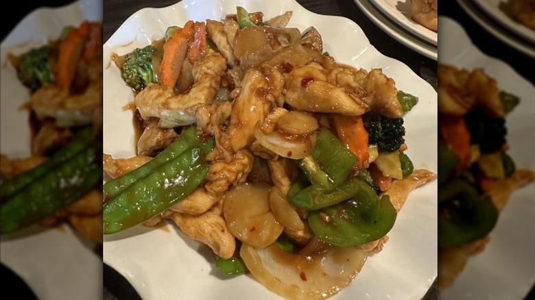 A white plate of Szechuan Chicken