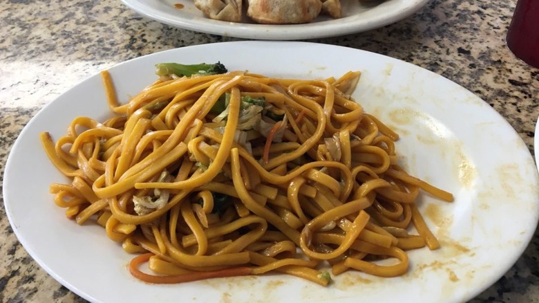 A white plate of vegetable lo mein