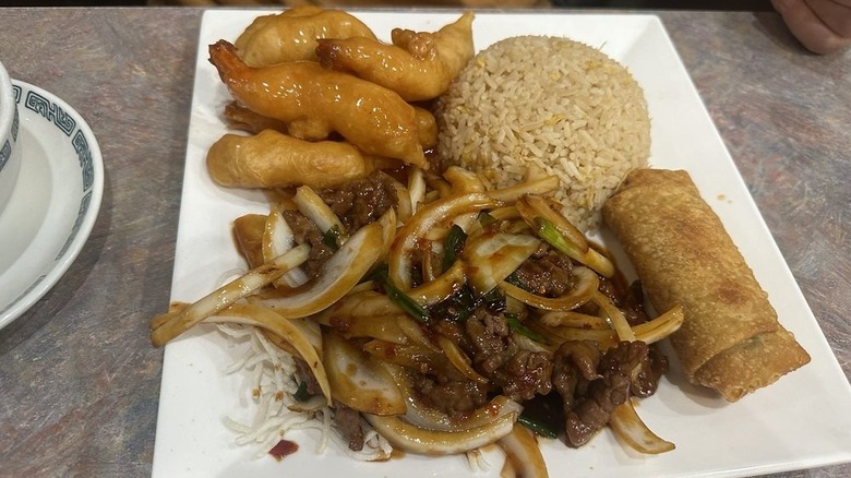 Sweet and sour shrimp with Mongolian beef and rice on a square white plate