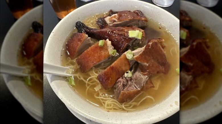 Duck noodle soup in a white bowl