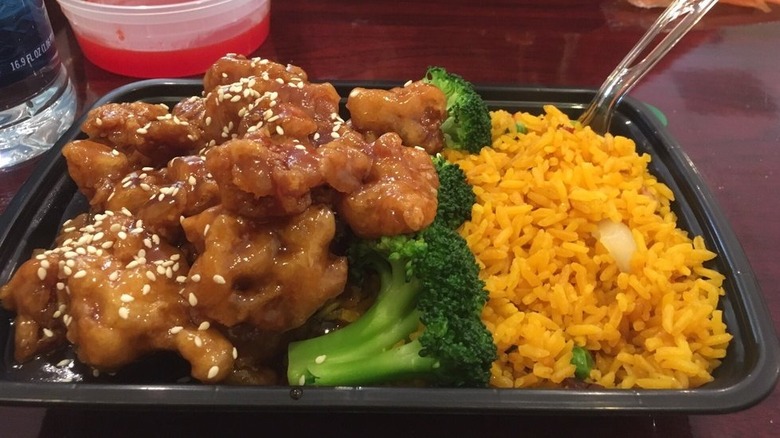 Sesame chicken with vegetables and rice in a to-go container