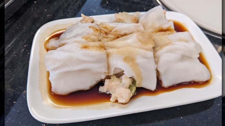 Shrimp rolls in sauce on a white plate