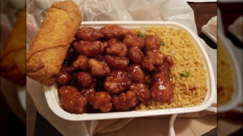 General Tsos chicken, pork fried rice, egg roll in a to-go container