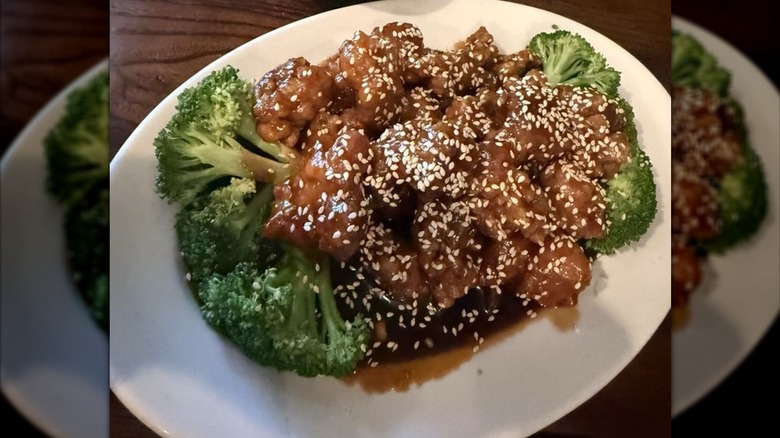 Sesame chicken and broccoli on a white plate