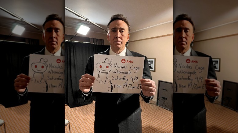 Nicolas Cage holding hand-drawn sign