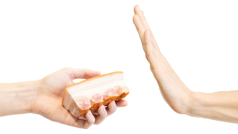 Hand waving away bacon