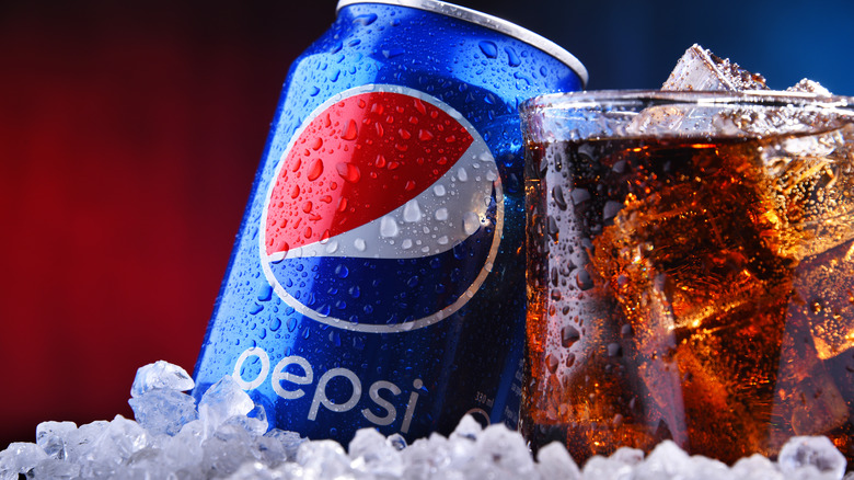 Pepsi can and glass of soda