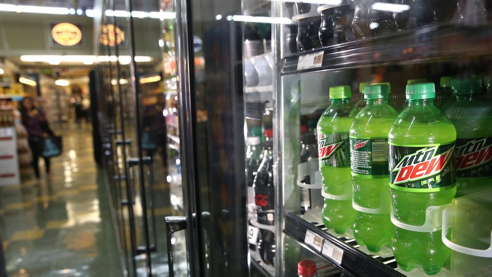 Bottles of Mountain Dew in a refrigerator