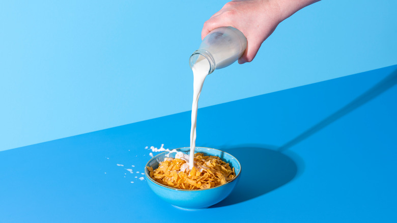 pouring milk into cereal