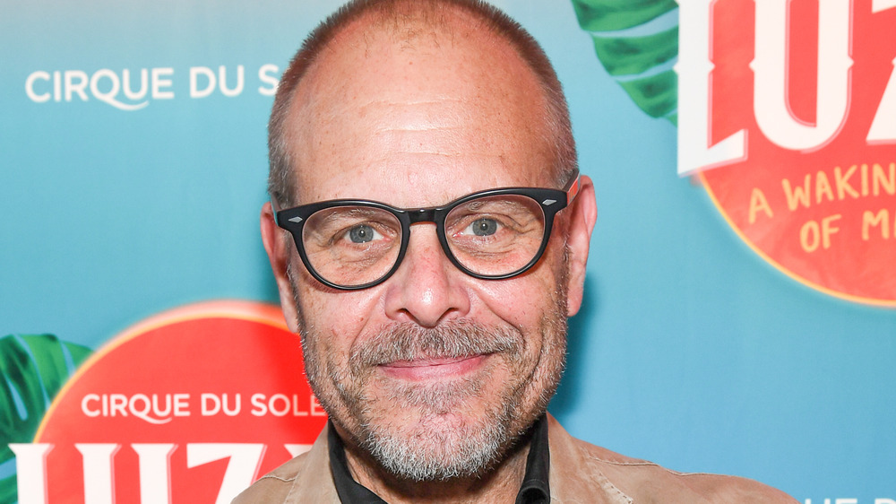 Alton Brown smiling in glasses