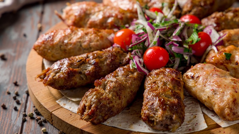 platter of kebab meat on skewers