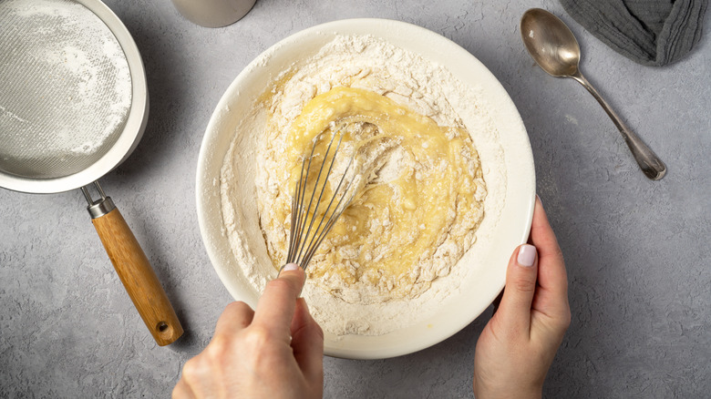 Overhead shot of someone mixing ingredients for baked goods