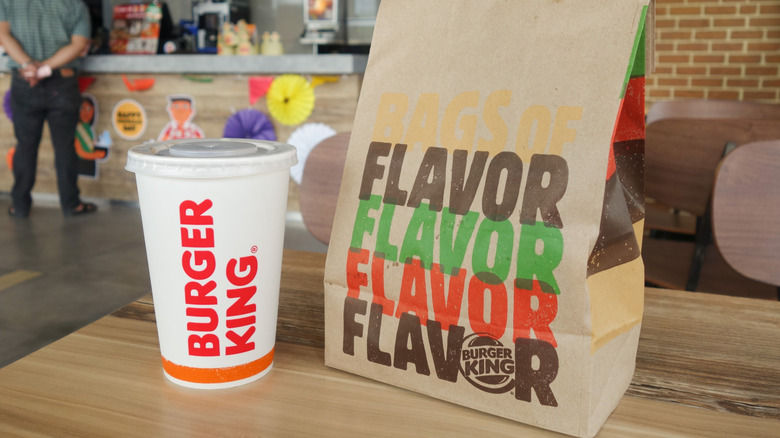 Burger King bag and drink on table