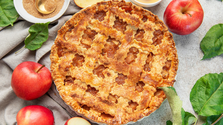 Closeup of apple pie and red apples