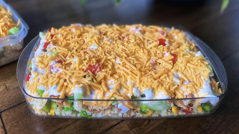 A picture of cornbread salad in a glass casserole dish.