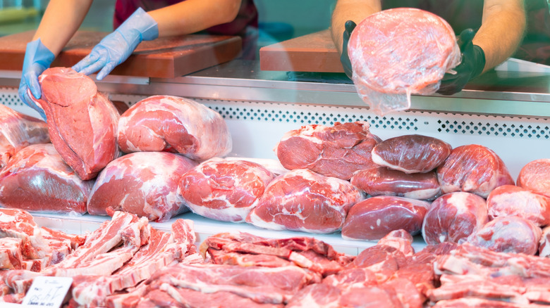 Butchers handling meat