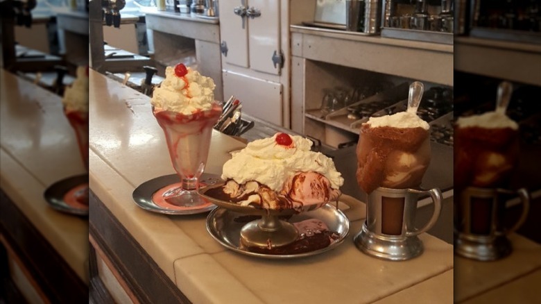 Milkshake, sundae, and float on marble countertop